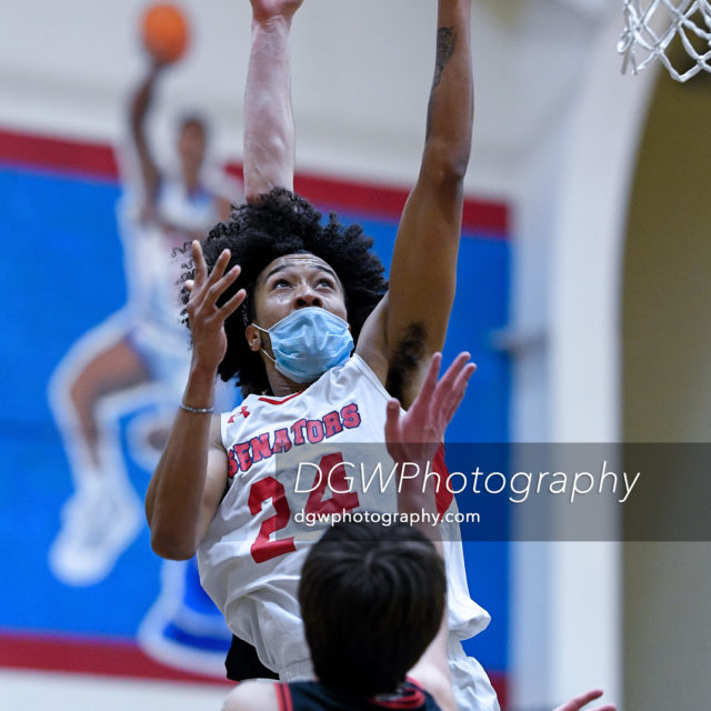 Brien McMahon's Kevin Pascual goes up for two against New Canaan High Monday night.