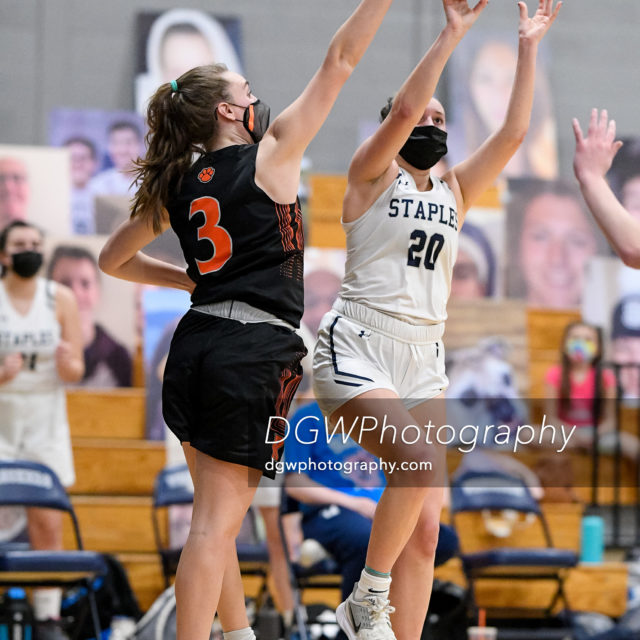 Ridgefield High's Kelly Chittenden blocks this shot by Lexie Moskovit of Staples High Saturday.