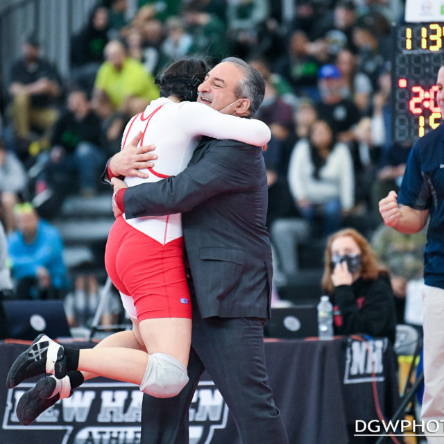 Foran High's Kelly Aspras leaps into the arms of coach Dave Esposito after winning the 138 lb title at the CT State Wrestling Open