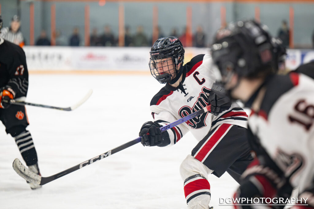 New Canaan's Max Lowe takes a shot on goal against Ridgefield